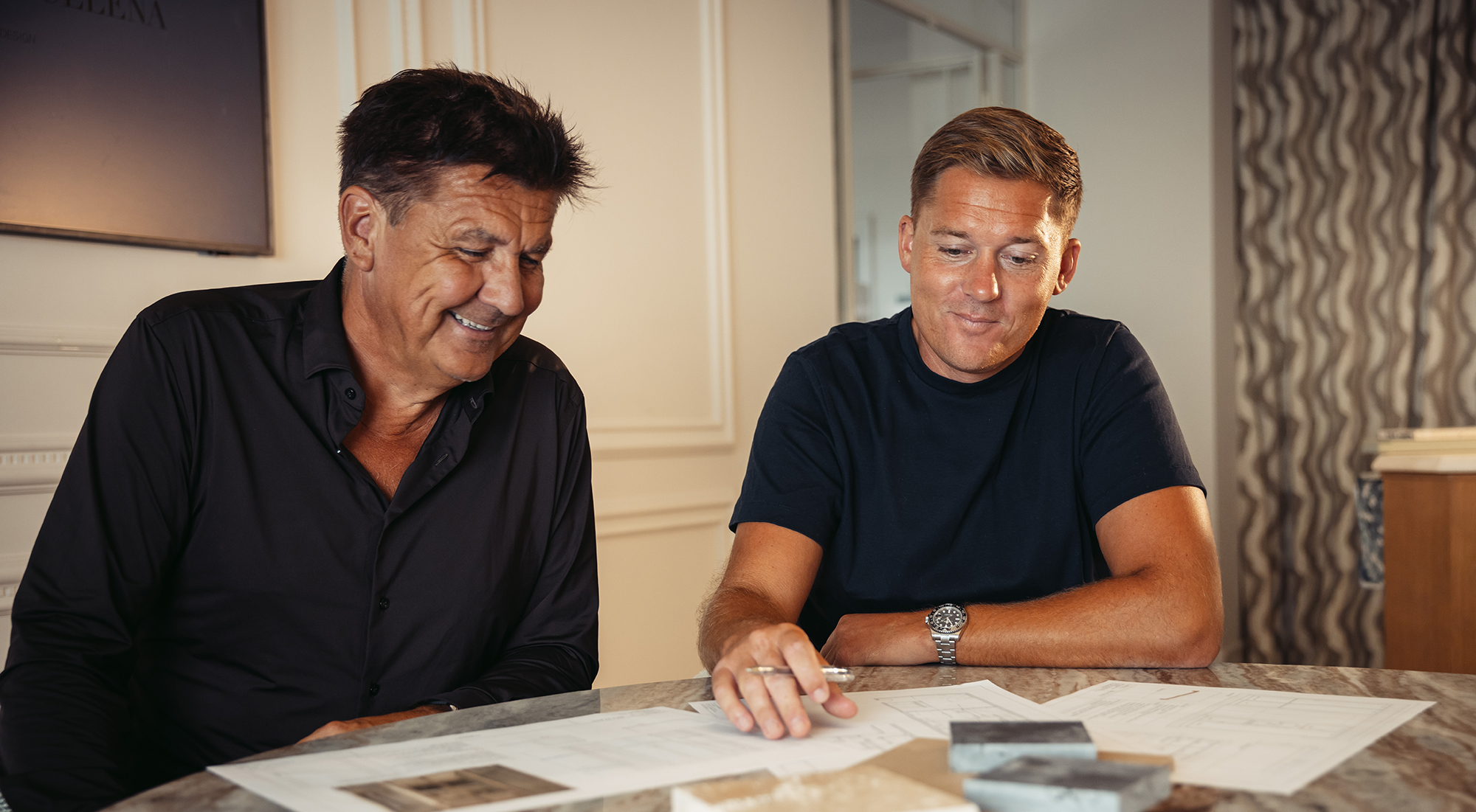 The Nordica Invest partners reviewing plans and material samples at the office
